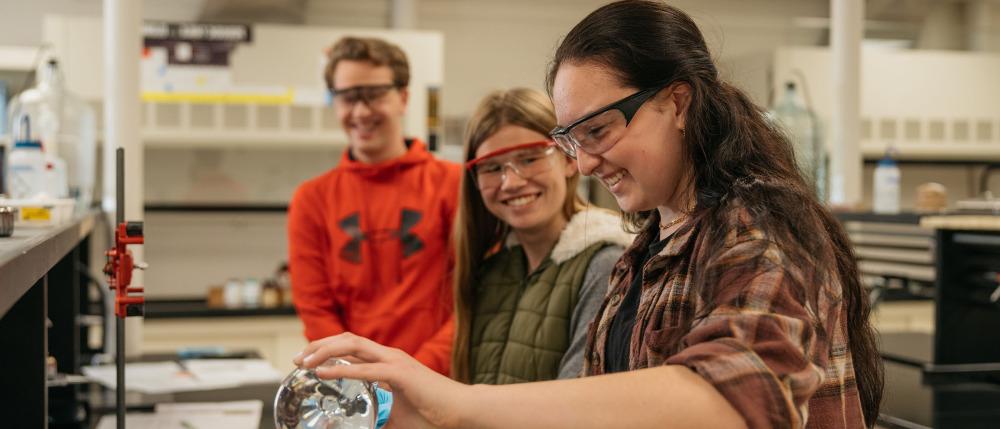 Students with safety glasses work in a lab